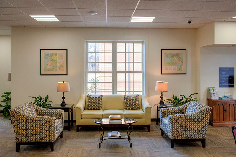 Seating area with couches and chairs in the lobby at Huguenot Road Baptist Church