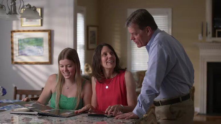 Pastor Bob Lee and his family looking through photos in their home